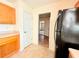 Kitchen area showcasing wooden cabinets, black appliances, and view towards additional rooms at 125 Whistle Way, Locust Grove, GA 30248