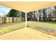 Covered back patio offers an ideal space for outdoor relaxation and entertainment at 125 Whistle Way, Locust Grove, GA 30248