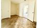 View of tiled room featuring white walls, two doors, and partial view of a garage space at 125 Whistle Way, Locust Grove, GA 30248