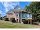 Back view of a brick home with an enclosed porch and a well-maintained lawn at 190 Winford Close, Duluth, GA 30097