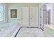 Elegant bathroom features a soaking tub, marble tile, and unique stained glass window at 190 Winford Close, Duluth, GA 30097