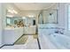 Bright bathroom featuring a soaking tub with marble surround, dual vanity, and glass enclosed shower at 190 Winford Close, Duluth, GA 30097