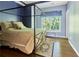 Comfortable bedroom featuring a four-poster bed, hardwood floors, and a bright window at 190 Winford Close, Duluth, GA 30097