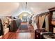 Spacious walk-in closet with clothing racks, a window, hardwood floors and overhead lighting at 190 Winford Close, Duluth, GA 30097