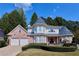 Charming brick home with well-manicured lawn, two-car garage, and turret accents at 190 Winford Close, Duluth, GA 30097