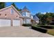 Brick home with a two-car garage and a long, curved driveway framed with hedges at 190 Winford Close, Duluth, GA 30097