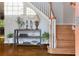 Foyer area with hardwood floors, staircase, decor table, and natural lighting at 190 Winford Close, Duluth, GA 30097