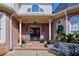 Inviting covered front porch with double doors, brickwork, and decorative plants at 190 Winford Close, Duluth, GA 30097