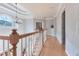Upstairs hallway featuring hardwood floors, decorative chandelier and tray ceiling at 190 Winford Close, Duluth, GA 30097
