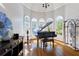 Elegant living room with hardwood floors, grand piano, and large windows at 190 Winford Close, Duluth, GA 30097