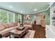 Inviting living room featuring hardwood floors, built-in shelving, and a bay window with views of mature landscaping at 190 Winford Close, Duluth, GA 30097