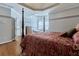 Spacious main bedroom boasts natural light, and an adjoined seating nook with a bright overhead chandelier at 190 Winford Close, Duluth, GA 30097