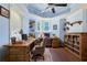 Home office features hardwood floors, vaulted ceilings, large windows, built-in shelving, and rustic wooden desk at 190 Winford Close, Duluth, GA 30097