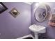 Stylish powder room with decorative mirrors, pedestal sink, and contrasting black tile floor at 190 Winford Close, Duluth, GA 30097