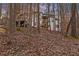 View of the house from the wooded backyard highlighting the walkout porches at 240 Grogans Lake Pt, Sandy Springs, GA 30350