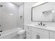 A clean, modern bathroom featuring a shower-tub combination, tiled wall, and a contemporary vanity at 240 Grogans Lake Pt, Sandy Springs, GA 30350