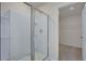 Clean bathroom with a glass shower and storage shelves at 2710 Serena Way, South Fulton, GA 30331