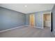 Bright bedroom with neutral walls, plush carpet, and an open closet space at 2710 Serena Way, South Fulton, GA 30331