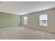 Sun-filled bedroom with carpet, two windows, and a green accent wall at 2710 Serena Way, South Fulton, GA 30331
