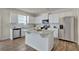 This kitchen has modern appliances, white cabinets and a central island with a stone countertop at 2710 Serena Way, South Fulton, GA 30331