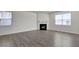 Spacious living room featuring a fireplace, multiple windows, and hardwood flooring at 2710 Serena Way, South Fulton, GA 30331
