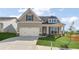 Charming home featuring a two-car garage, well-manicured lawn, and inviting front porch at 49 Masters Dr, Villa Rica, GA 30180