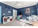 Blue bedroom with decorative shelves and a ceiling fan at 1265 Emerald Se Ave, Atlanta, GA 30316