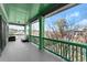 A charming covered porch with green pillars and railing, offering a tranquil outdoor space at 1265 Emerald Se Ave, Atlanta, GA 30316