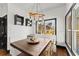 Charming dining area featuring rustic wood table, bench seating, and modern lighting fixtures at 1265 Emerald Se Ave, Atlanta, GA 30316