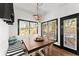 Cozy dining area with a rustic table, bench seating, and large windows offering natural light at 1265 Emerald Se Ave, Atlanta, GA 30316