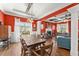 Inviting dining room featuring a rustic wooden table, bright red walls, and coffered ceilings at 1265 Emerald Se Ave, Atlanta, GA 30316