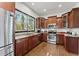 Well-equipped kitchen with stainless steel appliances, granite countertops, and dark wood cabinets at 1265 Emerald Se Ave, Atlanta, GA 30316