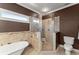 Elegant bathroom with a freestanding tub, glass-enclosed shower, and modern fixtures at 1265 Emerald Se Ave, Atlanta, GA 30316
