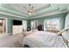 Main bedroom showcasing tray ceiling, TV, and natural light from windows at 1265 Emerald Se Ave, Atlanta, GA 30316