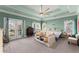Bright main bedroom with tray ceiling, ceiling fan, and access to a private balcony at 1265 Emerald Se Ave, Atlanta, GA 30316