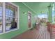 Inviting front porch with wood flooring, green walls, and decorative windows at 1265 Emerald Se Ave, Atlanta, GA 30316