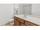 Bright bathroom featuring a single sink vanity with wood cabinets and a combined shower-tub at 1536 Baxley Pine Trce, Suwanee, GA 30024