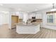 Open kitchen with granite countertops, white cabinets, and stainless steel appliances at 1536 Baxley Pine Trce, Suwanee, GA 30024