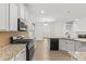 Spacious kitchen featuring stainless steel appliances, and a large island with granite countertop at 1536 Baxley Pine Trce, Suwanee, GA 30024