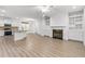 Open concept kitchen and living space with fireplace and built-in shelving at 1536 Baxley Pine Trce, Suwanee, GA 30024