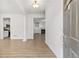 Bright living room with modern floors, fresh white paint, and a view of the kitchen and fireplace at 1536 Baxley Pine Trce, Suwanee, GA 30024