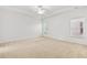 Large main bedroom features neutral carpeting, a ceiling fan, and two large windows at 1536 Baxley Pine Trce, Suwanee, GA 30024