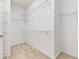 Spacious walk-in closet with carpeted floor and metal shelving at 1536 Baxley Pine Trce, Suwanee, GA 30024