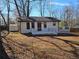 Charming single-story home with a deck and a well-maintained front yard, offering a cozy and inviting appeal at 1580 Turner Rd, Cumming, GA 30041