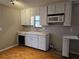 Practical kitchen layout with essential appliances and ample cabinet space, designed for efficiency at 1580 Turner Rd, Cumming, GA 30041