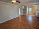 Open-concept living area with hardwood floors and a ceiling fan, seamlessly connects to the kitchen at 1580 Turner Rd, Cumming, GA 30041