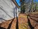View of the leafy side yard and outer wall at 1580 Turner Rd, Cumming, GA 30041
