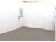 An unfinished basement featuring painted floors, neutral walls, and two doors at 1630 Versailles Dr, Atlanta, GA 30331