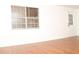 Bright bedroom with faux-wood floor, white walls, window with blinds, and glass-paneled door at 1630 Versailles Dr, Atlanta, GA 30331