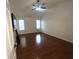 Spacious bedroom featuring hardwood floors, a ceiling fan, and plenty of natural light at 1630 Versailles Dr, Atlanta, GA 30331